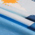 A microfibre beach towel featuring a blue design with sun and cloud graphics, showcased in a folded position.