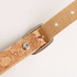 A cork luggage tag featuring a natural cork texture and a metallic buckle, with a beige strap.