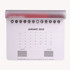 A mouse mat in white with a 2025 calendar layout, featuring a grey edge and icons across the top.