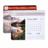 A calendar mouse mat featuring a scenic landscape design with a monthly calendar layout, predominantly in blue and white tones.