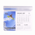 A mouse mat featuring a calendar for January 2027, with an image of a snowboarder and vibrant blue and white colours.