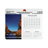 A calendar mouse mat featuring a scenic image and a layout of months in grey and white. It also includes a logo.