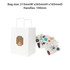 A white kraft paper bag with flat handles and assorted colourful stickers beside it.