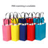 A collection of colourful gift bags in pink, yellow, blue, red, and navy, featuring black handles and a logo.