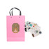 A pink knitted handle bag with a bear design, accompanied by a collection of decorative stickers.