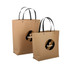 A medium brown paper bag with black handles and a circular logo in the centre.