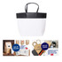 A medium black and white boutique paper bag with two handles, featuring a logo on the front.
