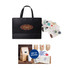 A large black paper bag with flat handles, accompanied by assorted stickers, including decorative designs and labels.