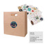 A brown kraft paper bag with a handle, featuring a circular logo and assorted decorative stickers beside it.