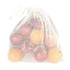 A white organic cotton mesh bag filled with vibrant apples in various colours. The bag has a drawstring closure and a logo.