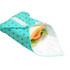 A reusable food wrap in aqua with white polka dots, partially covering a sandwich with lettuce and tomato.