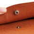 A close-up of an orange PU leather A4 file bag, highlighting its textured surface and snap closure.