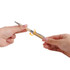 A 2 in 1 crystal stylus pen with a gold barrel and a decorative glitter section, held between two hands.