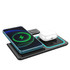 A portable wireless charger in black, featuring a smartphone and earbuds, with a sleek design and glowing accents.
