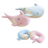 A plush travel pillow shaped like a whale, featuring pink and light blue colours, with a logo on the side.