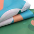A hexagon outdoor blanket measuring 280x210cm, featuring vibrant blue, green, and peach patterns. It has a logo.