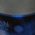 A blue oval popup booth with a smooth, dark top surface, featuring an abstract design.