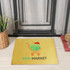 A yellow polyester logo mat featuring a graphic with a shopping cart and a logo. Ideal for floor placement in business settings.
