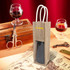 A jute wine carrier in natural colour with a window, featuring two handles and a logo, displayed on a vintage table setting.