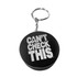 A black keyring featuring a hockey puck stress reliever with white text and a metal attachment.