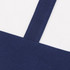 A medium canvas tote bag in white with a navy blue base and straps, featuring a branding logo.