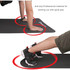 A black premium TPE yoga mat featuring an anti-slip surface, with a person's hand and foot positioned on it.