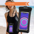A waterproof universal cellphone dry bag in black, holding a smartphone, with a lanyard. Design logo visible.