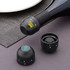 A drink bottle stopper in black, featuring a logo, designed for champagne. Includes two additional similar stoppers.