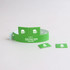 A green PVC wristband with two tabbed attachments, featuring a logo and icons.