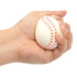 A hand squeezing a white baseball-shaped stress reliever with red stitching. The product has a logo.