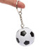 A keyring featuring a small, black and white football stress reliever. It includes a metal chain for attachment.