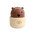 A brown and cream dog treat dispenser toy resembling a bear, with a playful expression and a branding logo.