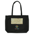 A black tote bag with a patterned panel and a logo at the bottom. Features two sturdy handles.