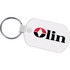 A rectangular soft key tag in white featuring a logo, attached to a metallic key ring.