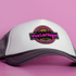 A grey and white cap featuring a round logo with vibrant pink and black elements.