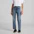 Straight jeans in a light blue wash, styled with a white crop top and black sneakers. The jeans have a subtle logo detail.