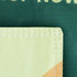 A green garden flag featuring a stitched corner detail in light green fabric. It has a logo or branding element.