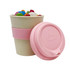 A bamboo cup featuring a pink silicone band and lid, filled with colourful jelly beans. The cup has a logo.