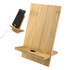A bamboo phone holder with a sleek design, featuring a stand and a slot for charging cables.