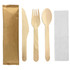 A wooden cutlery set featuring a knife, fork, and spoon in light wood tones, accompanied by a napkin and packaging.