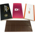 A brown 100g chocolate bar is displayed alongside two promotional boxes with different designs and logos.