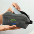 A grey toiletry bag with a zippered closure and a logo, holding a light blue bottle.