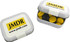 A small rectangular tin containing yellow and black choc beans, with a logo on the lid.