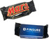 A Mars Bar wrapped in black packaging with bold red lettering, alongside a blue box featuring a logo.