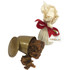 A gold container spilling a rich, dark brown Christmas pudding, wrapped in cream fabric and tied with a red ribbon.