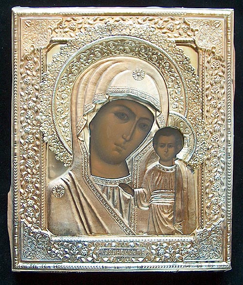 The riza is marked with a silver mark  "84"  a maker's  mark (P.T.) and a right facing kokoshnik with triangle. The lower edge of the riza also has a full maker's mark for the V.S. Krestyaninov Factory, Moscow. The painting has been touched up in two places on the Madonna's face and there is some minor chipping of the paint where the riza has rubbed against the panel. The wood panel is covered at the back with faded red velvet.