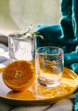 La Rochere Libellules Tumbler on a tray with an orange sliced in half