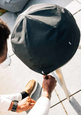 A man tightening the weather resistant fabric cover on the moon 45 outdoors