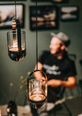 Candles lit indoors in the Höfats Gravity Candle Hanging System – Stainless Steel Candles lit indoors in the Höfats Gravity Candle Hanging System – Stainless Steel