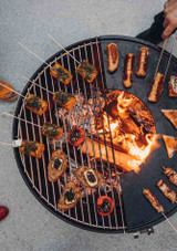 Cooking outdoors on the grill and the plancha on the bowl 70 fire pit